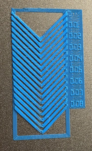 3D print consisting of chevrons with numbers next to them, that run from 0 to 0.08 in 0.01 steps