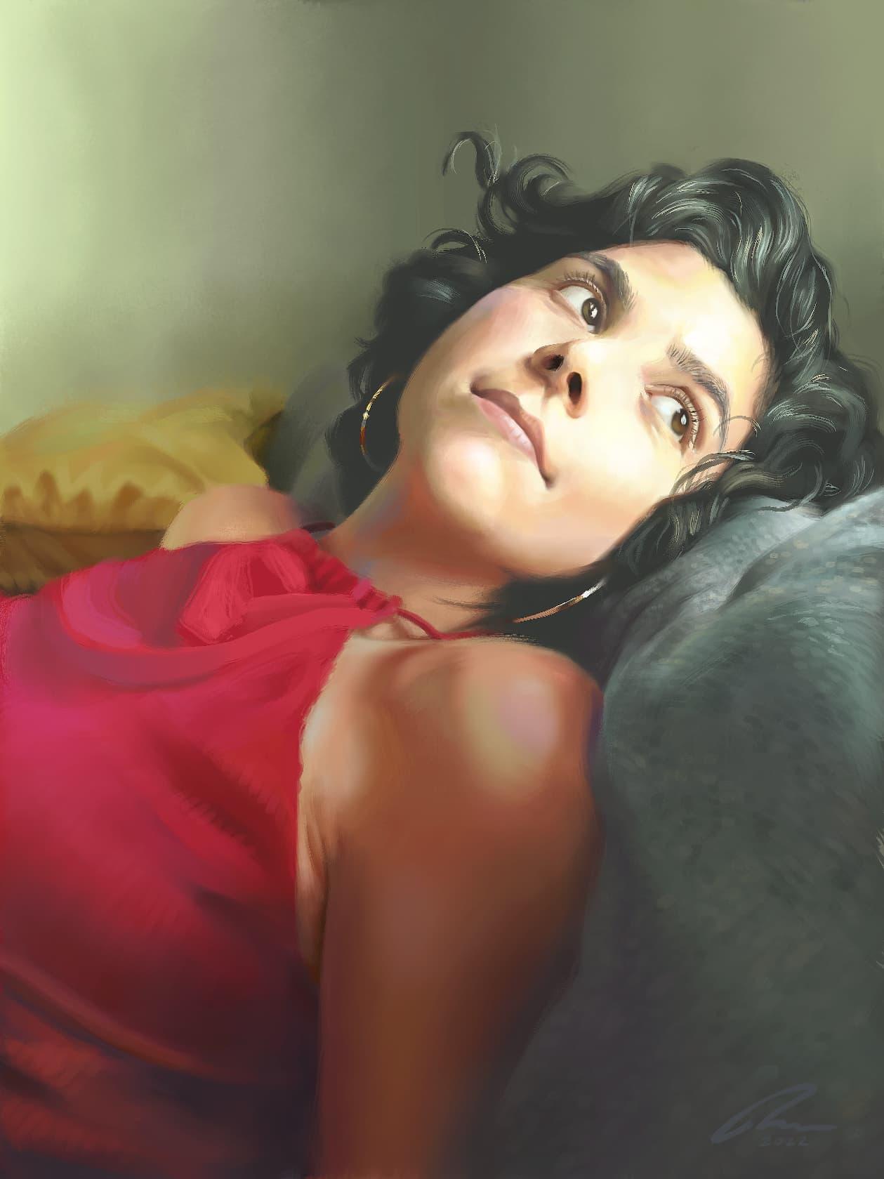 Portrait of a lovely young woman laying back on a comfortable couch. She is wearing a red knitted blouse and a pair of silver earrings. Her face, bathed by sunlight, turns away to see the world outside her window.