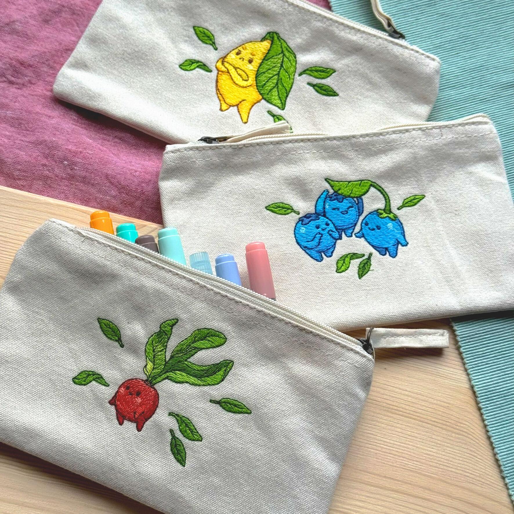 3 embroidered cotton pencil cases with cute veggie characters: A lemon, blueberries and a red radish
