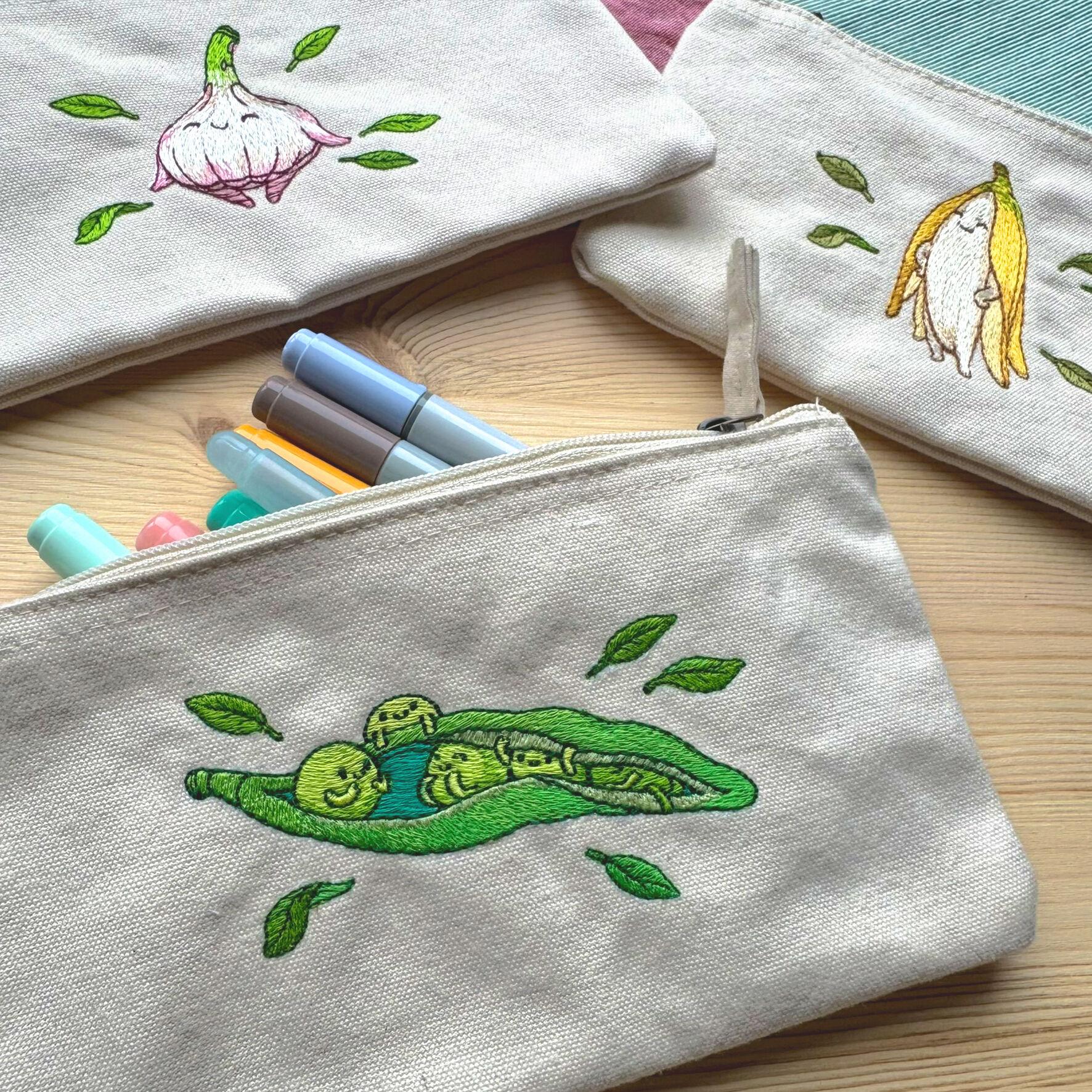 3 more pencil cases, one with peas, one with garlic and one with a banana