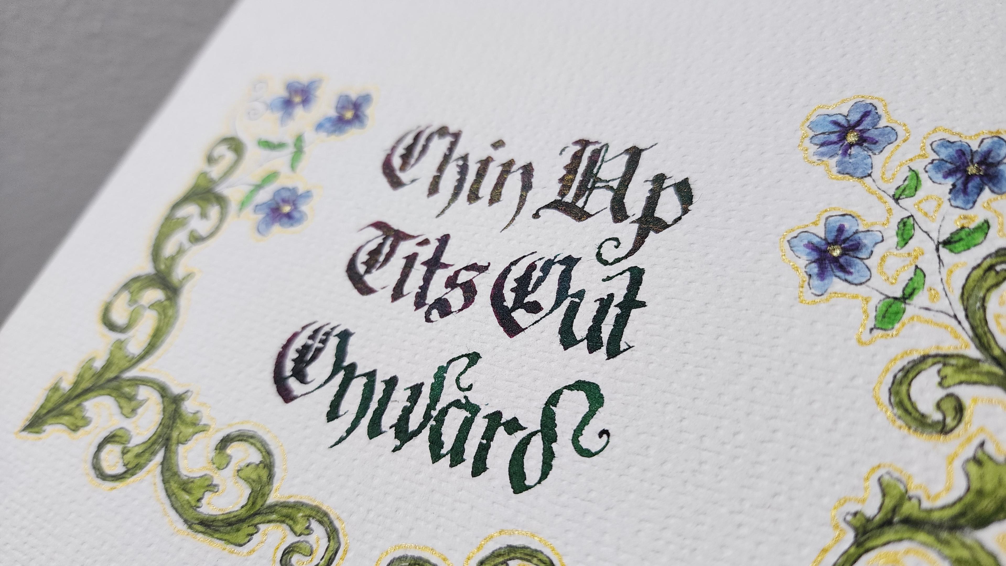 Angled view showing the sparkle and colour-change in the lettering, and the gold outline around the decorations