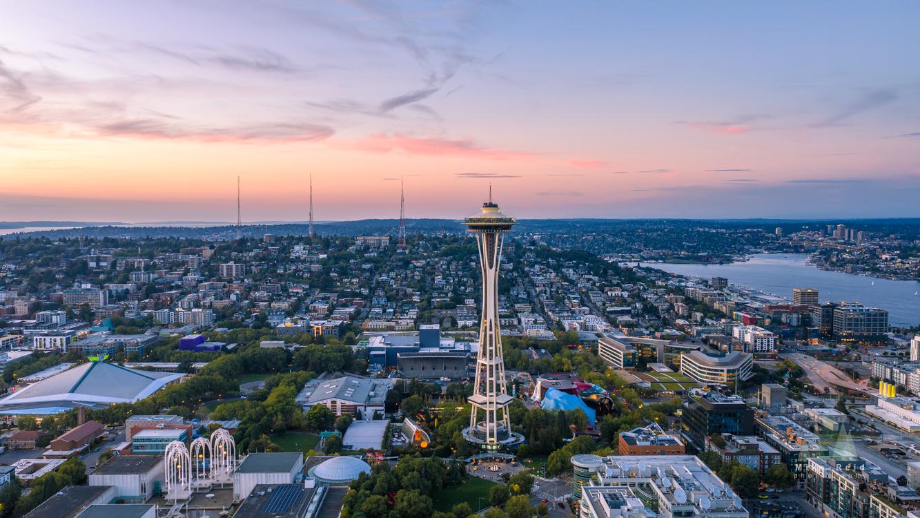 Aerial view of Seattle's Space Needle in evening light, surrounded by the Seattle Center Grounds.
Aerial view of Seattle's Space Needle in evening light, surrounded by the Seattle Center Grounds.