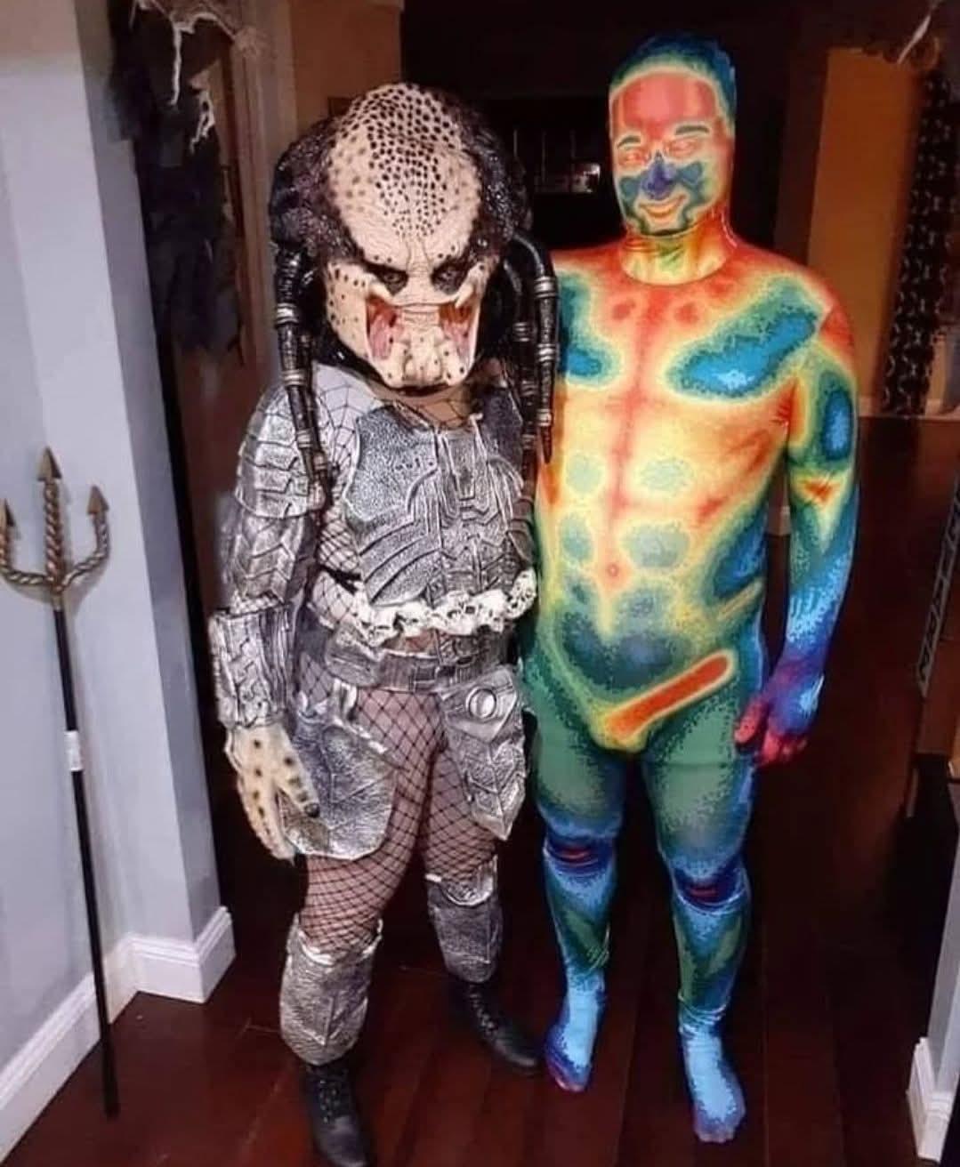 Photo of two people dressed up as Predator and a person as thermal vision of Predator.
