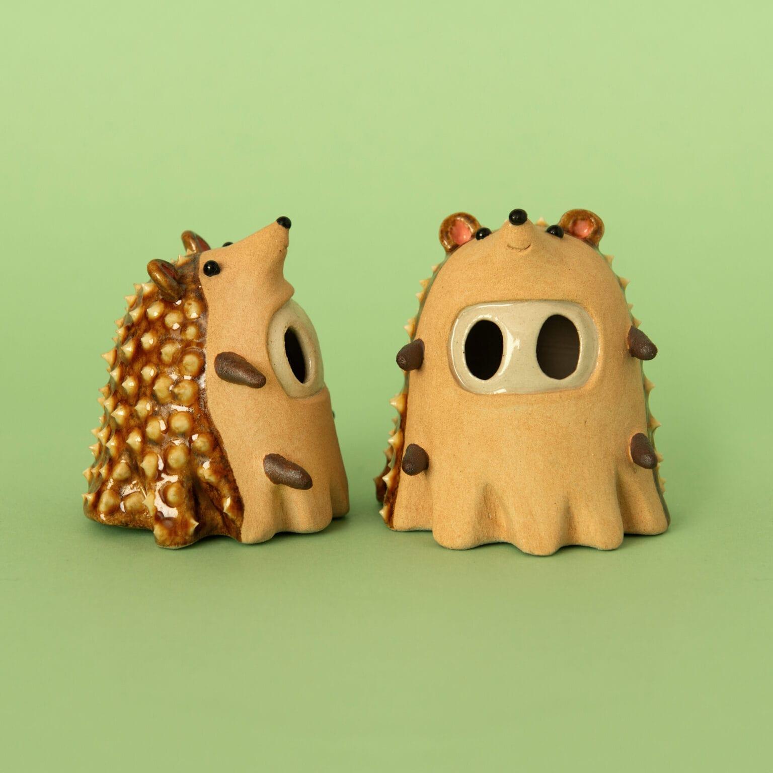 2 small ceramic ghosts posing as hedgehogs