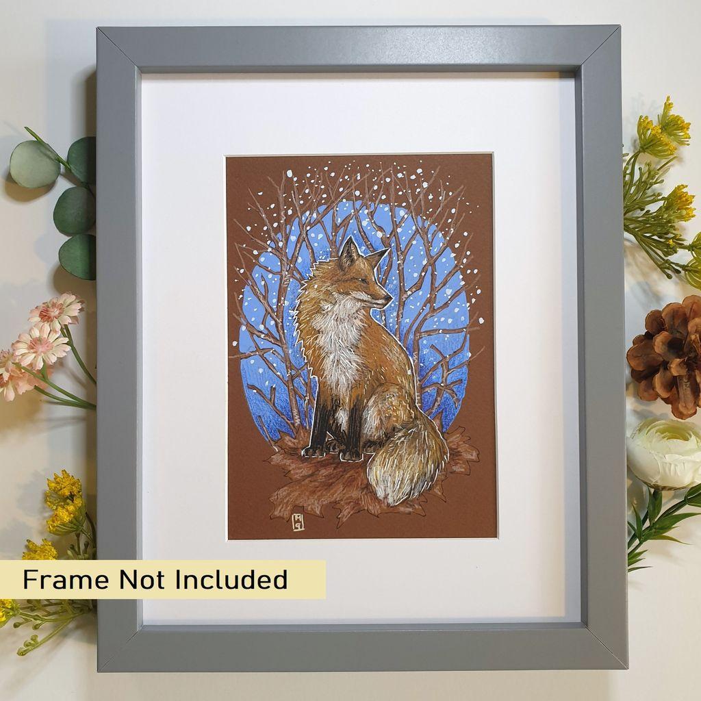 A small drawing of a red fox surrounded by branches and snow in an oval design.
An original art work, please note that the frame is not included.
Colour pencil and mixed media on acid free toned artist paper
5 by 7 inches (12.7 by 17.8 cm).