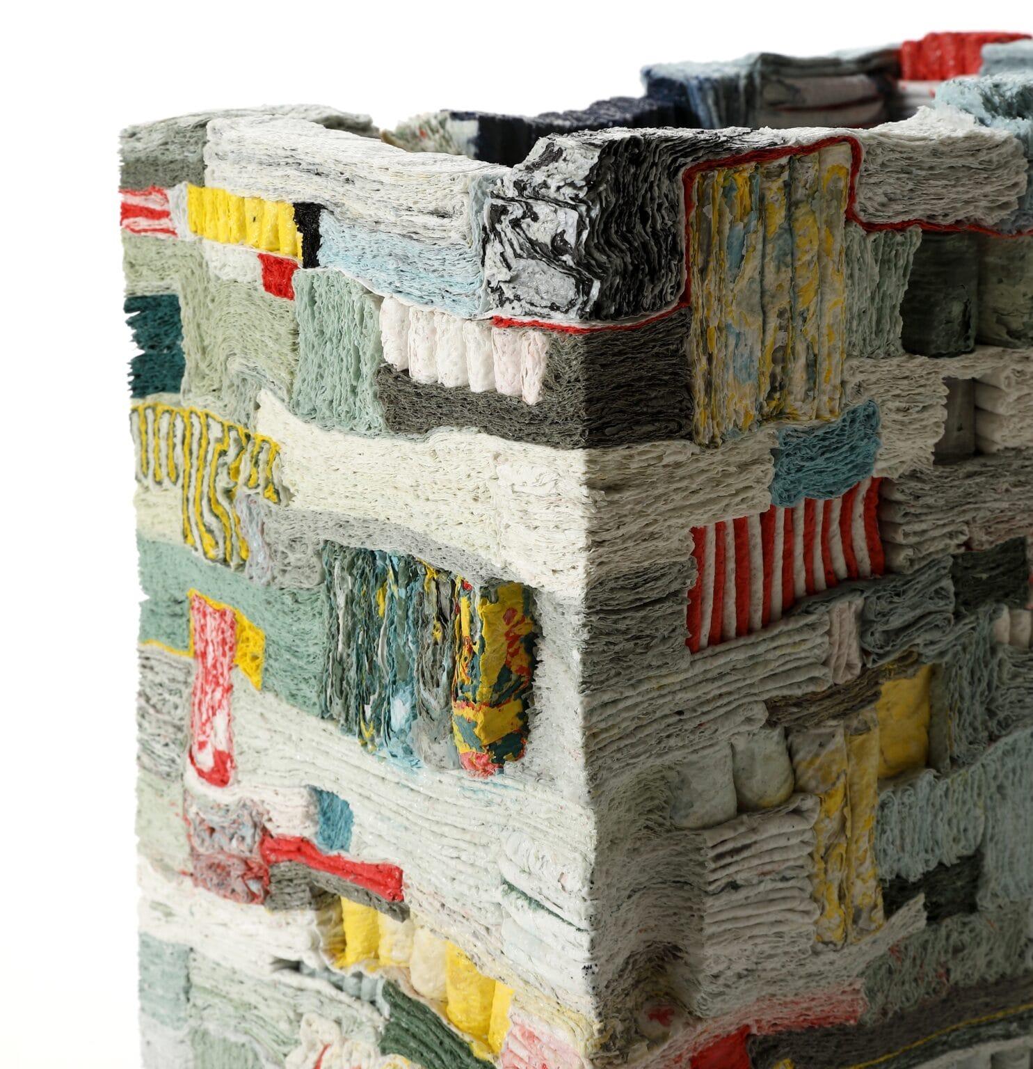 a square sculpture made of layered and folded slip by Jongjin Park