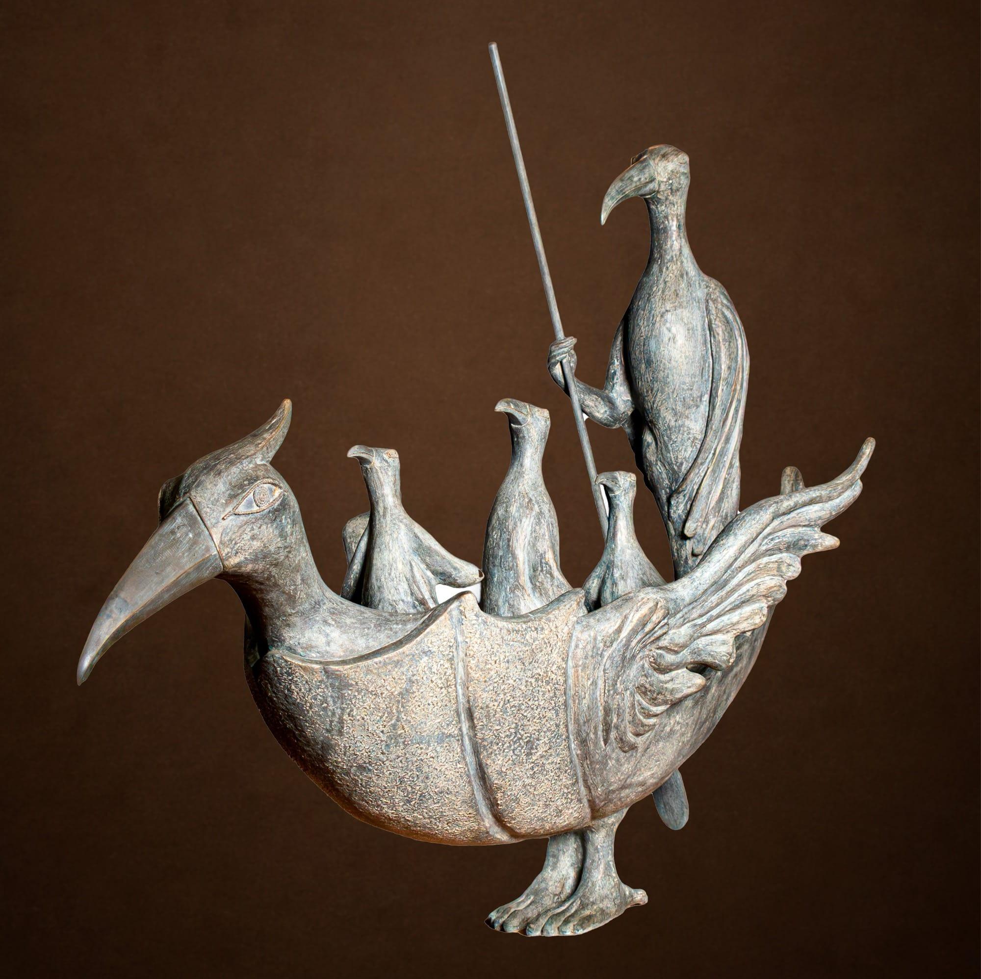 a bronze sculpture of a large bird that is being ridden by other smaller birds as if it is a boat
