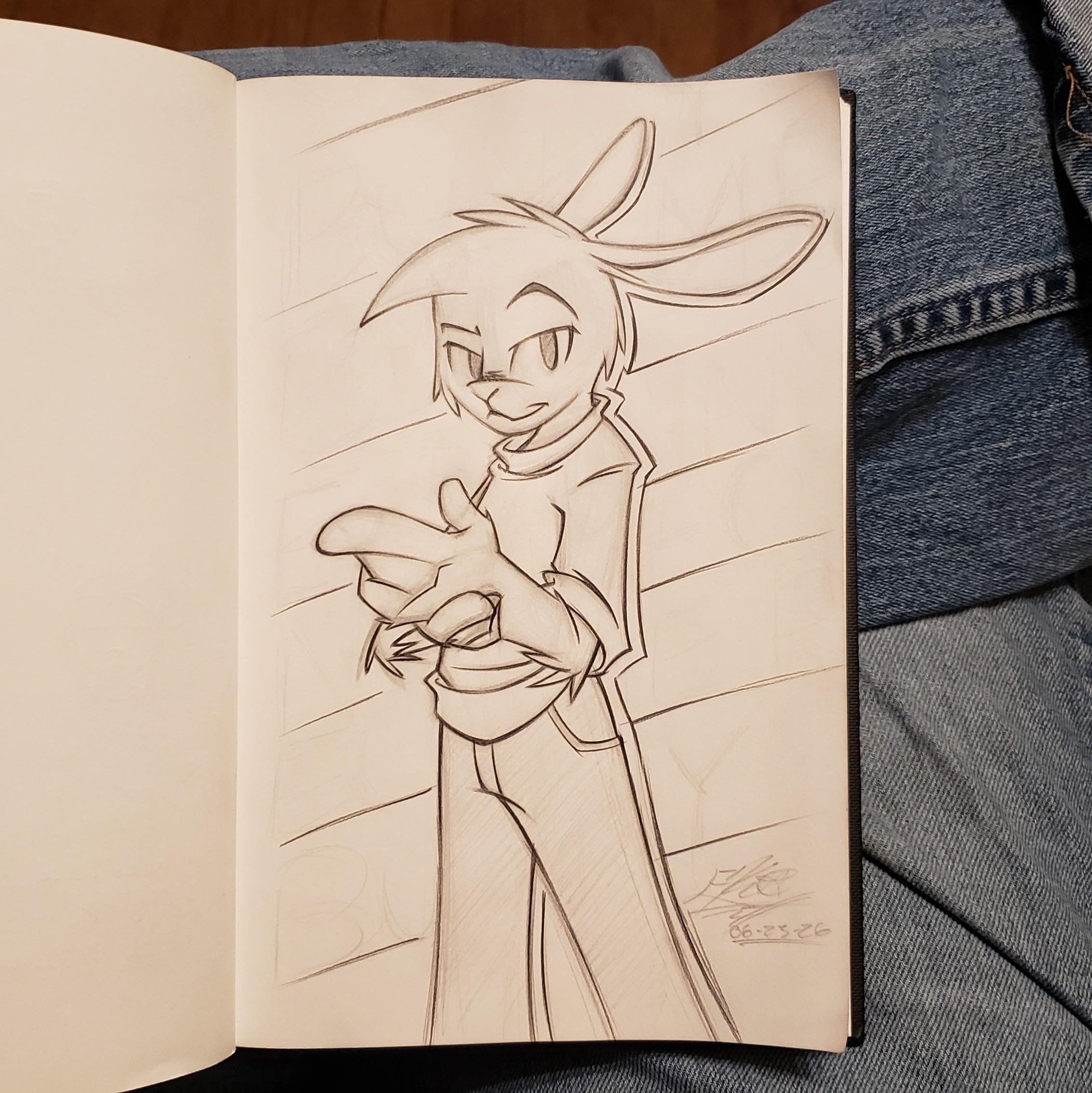 Photo of my sketchbook. On the page is an anthro Bunny sporting jeans and a t-shirt looking toward the viewer. It's a fairly simple pose with a twist. The bunny boy is holding his left hand. We catch a glimpse of his right arm and hand still looking a bit human. He stands in front of kinda' sorta' blank signage that, if done right, was going to say "Become Bunny" repeated across the various lines.