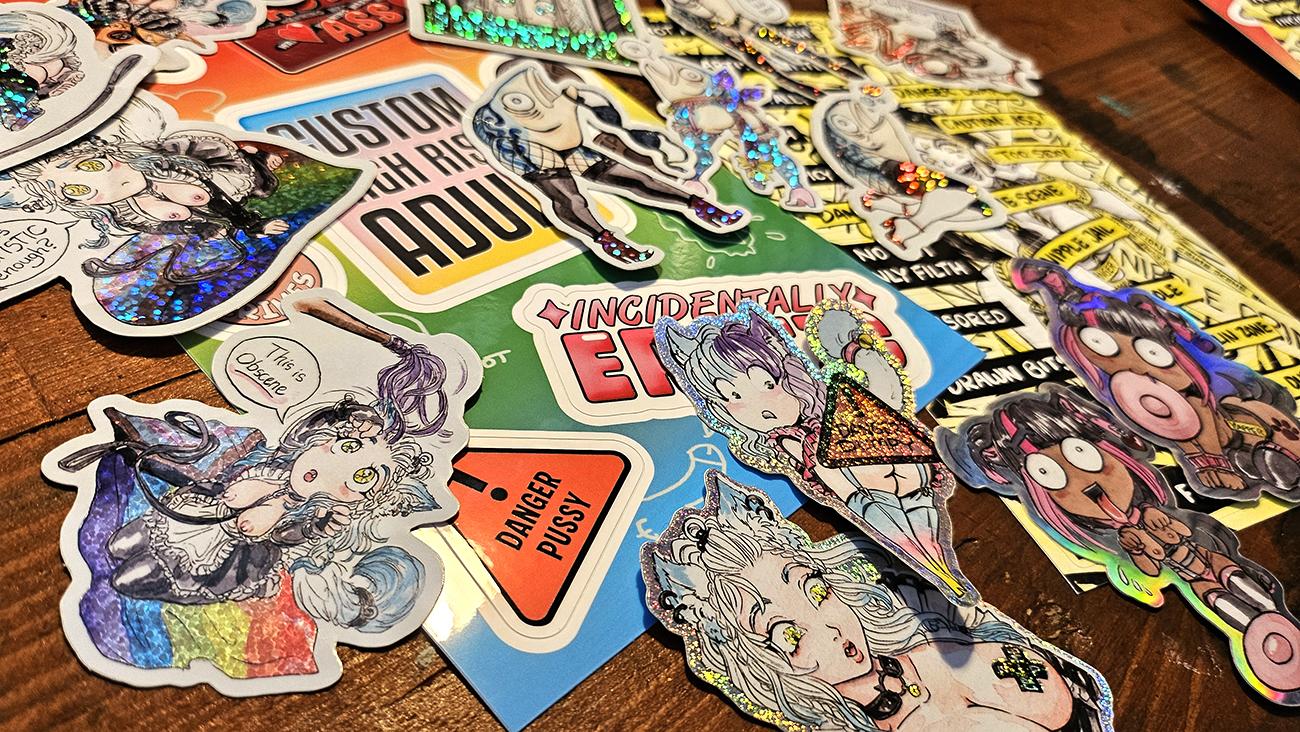 A whole pile of a bunch of stickers lots of cat girls and gay shit