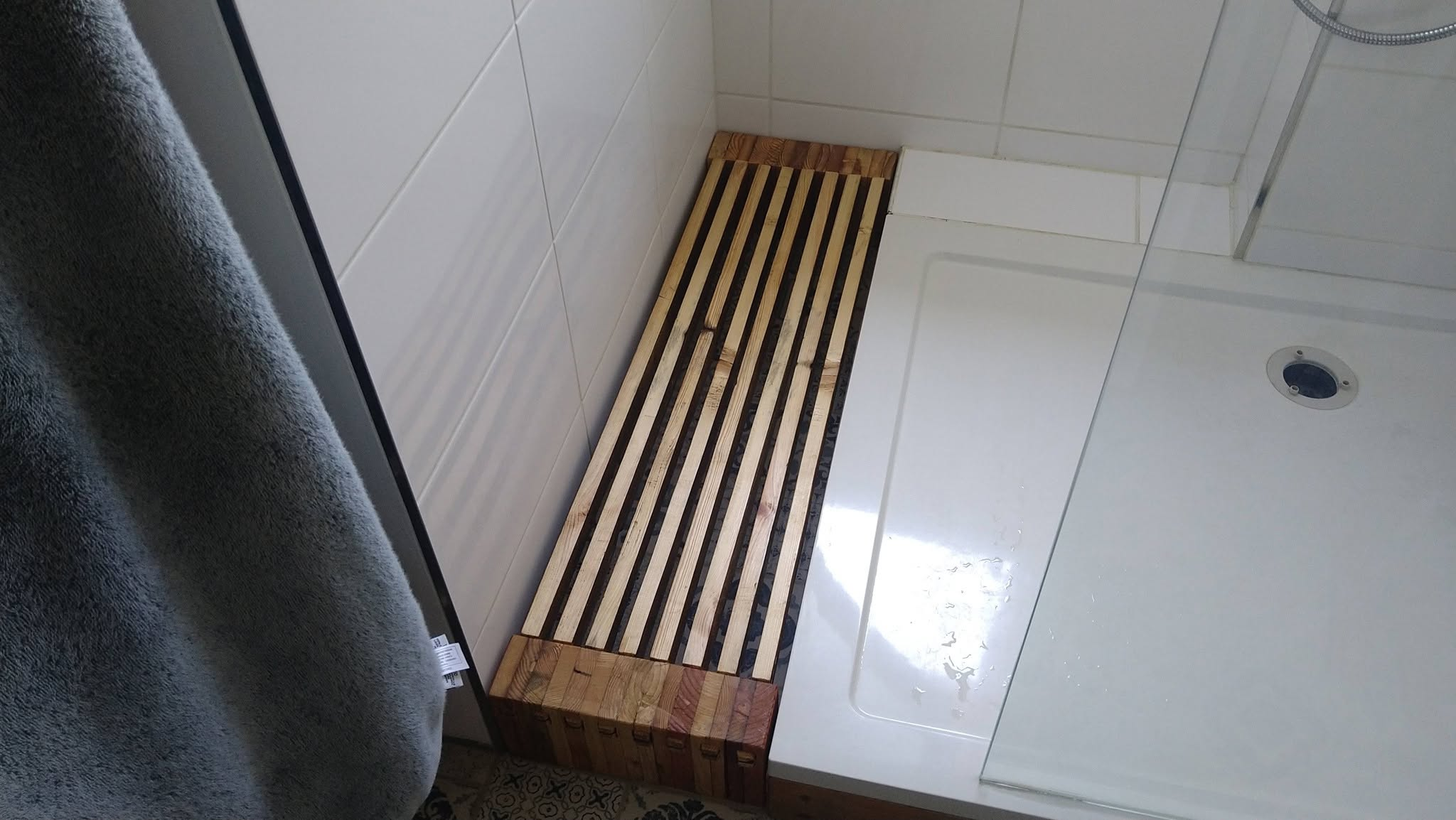 Photo of the duckboard fitted in it's spot next to the shower in my bathroom
