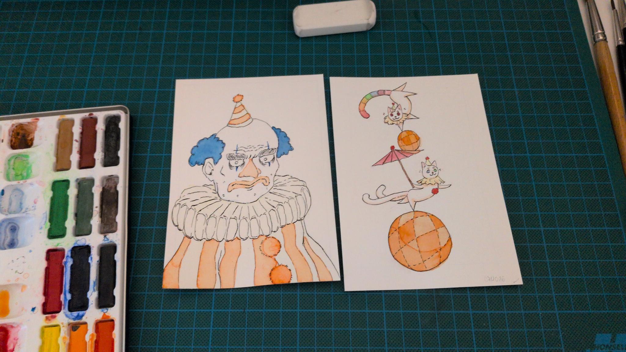 two DIN A6 post cards in progress of a clown and two cat acrobats
