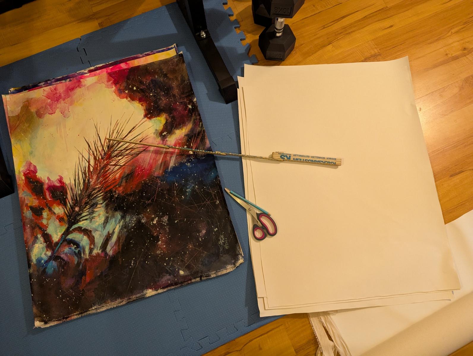 The cut pieces of canvas, white and empty, lying next to a small stack of painted ones, scissors and ruler on top. There are also dumbbells, because I'm doing that in my small gym. Which is quite cramped.