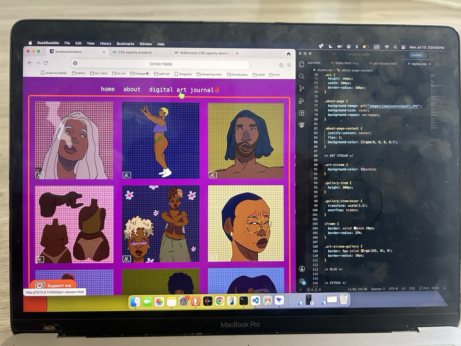 my laptop screen displaying my website art gallery and code editor side by side