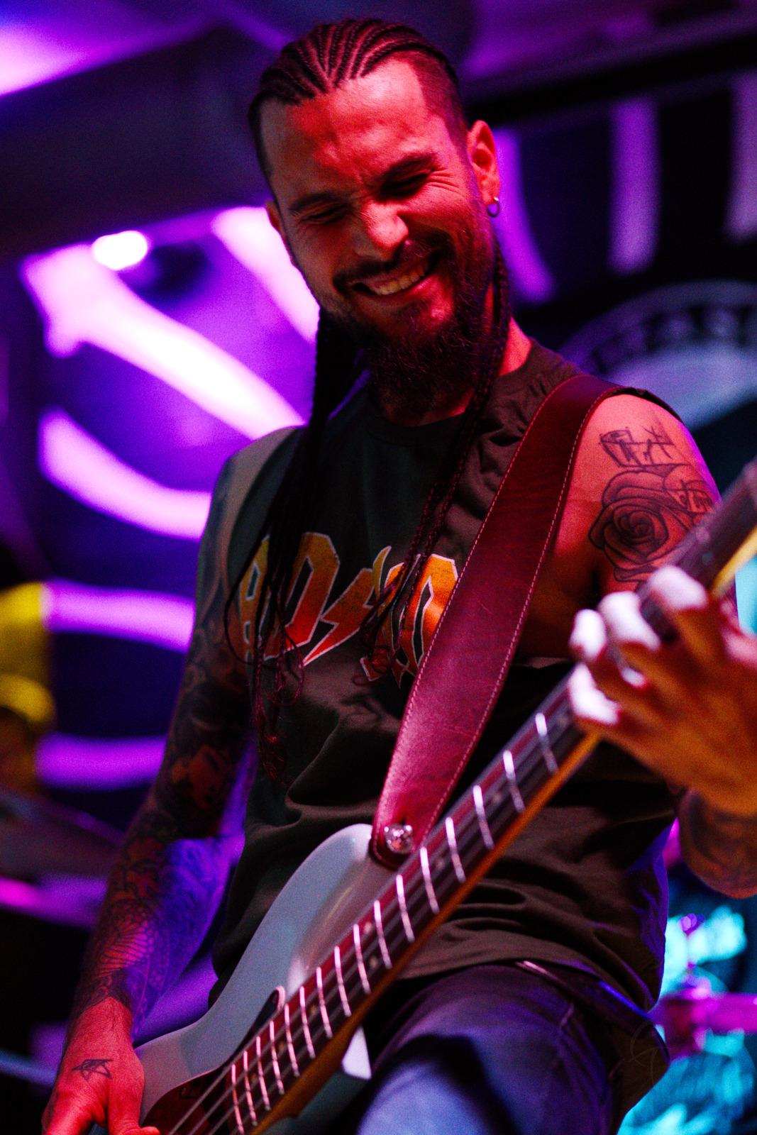 Bass player making a face during a difficult riff