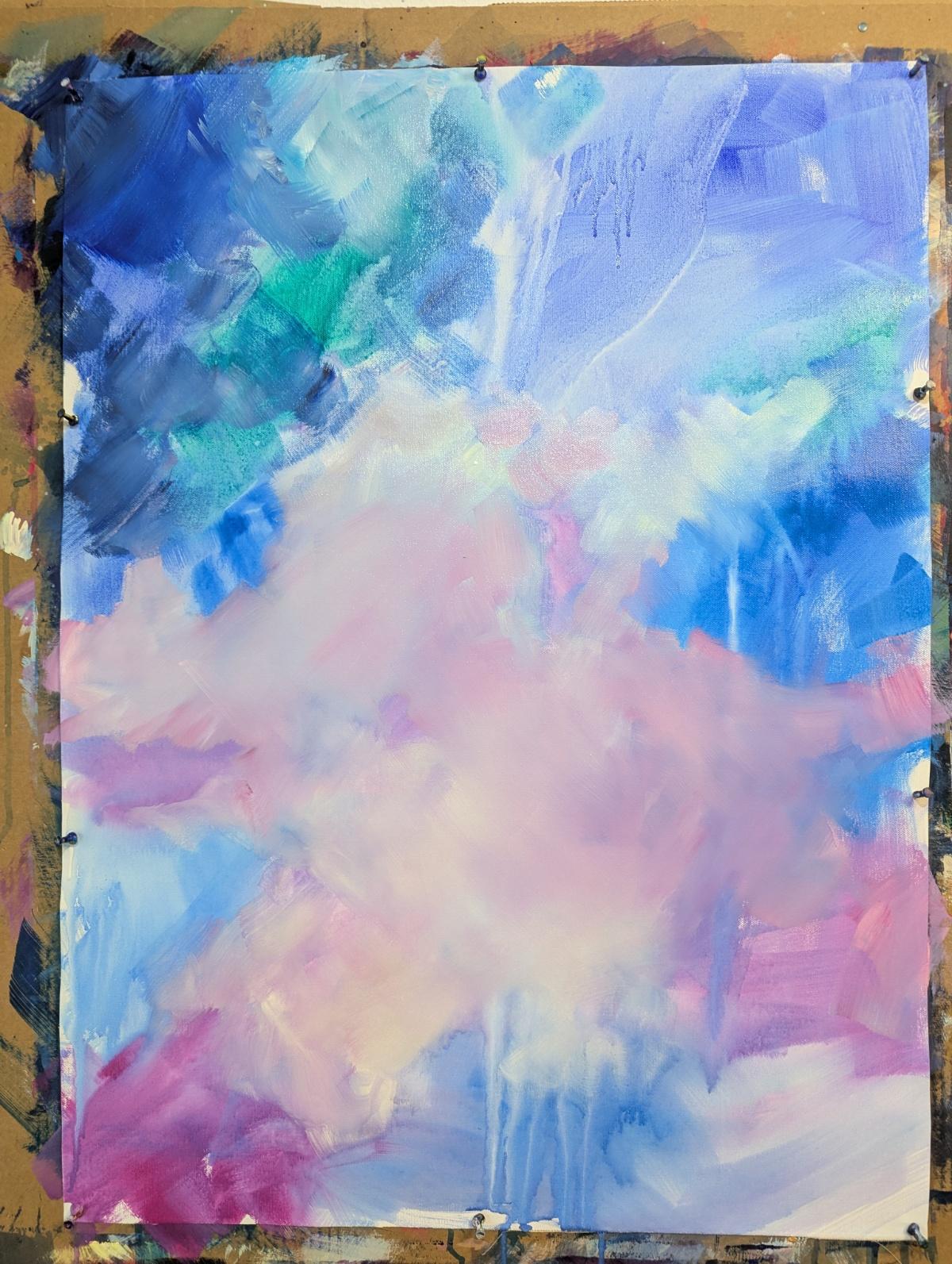 A canvas on a wall easel, covered in soft clouds of pastel pinks and blues