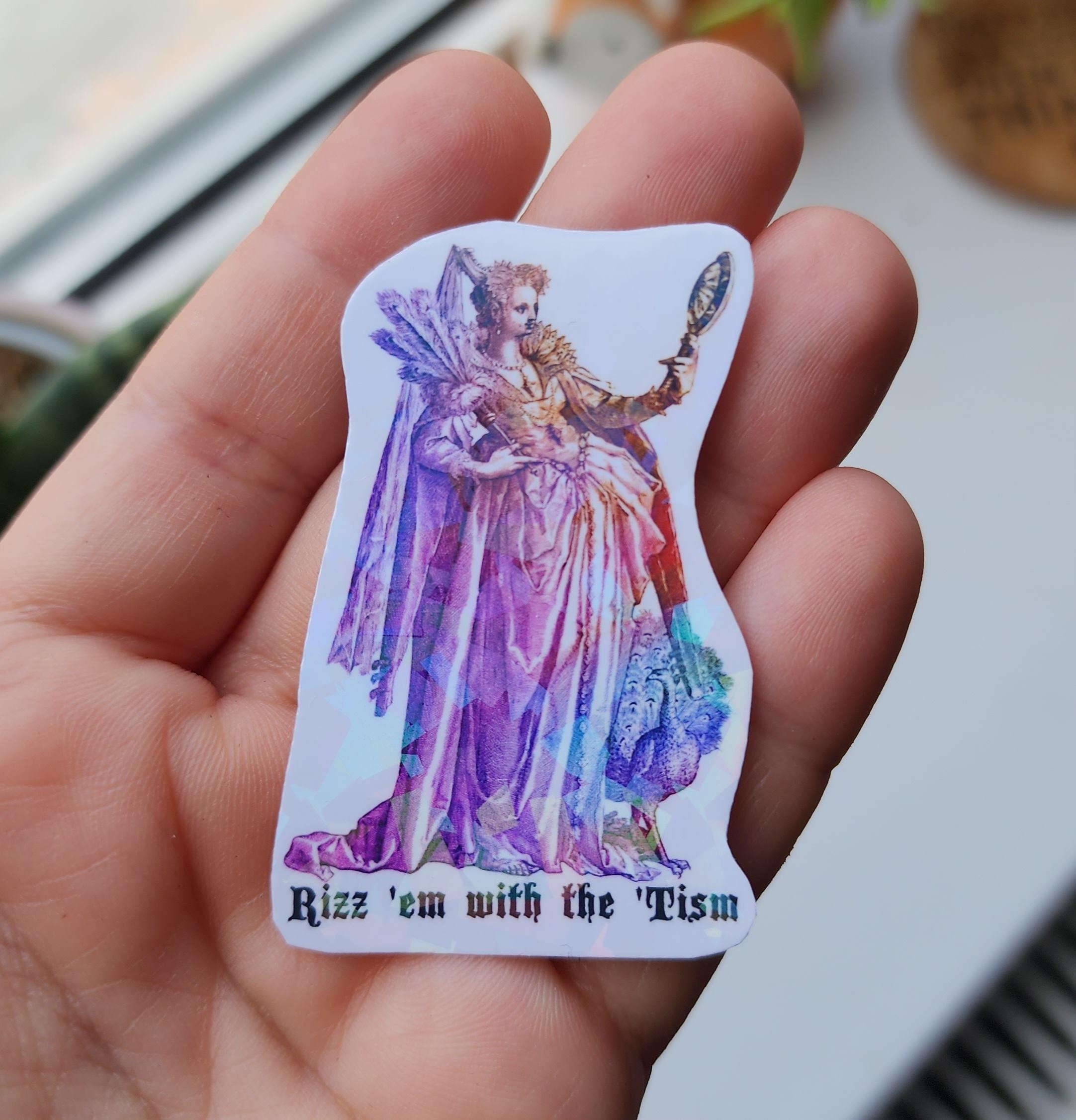A holographic sticker with a vintage illustration of a fem wearing a fancy ballgown, preening in a hand mirror, with a peacock to the side, and the words 'Rizz 'em with the 'Tism' underneath.