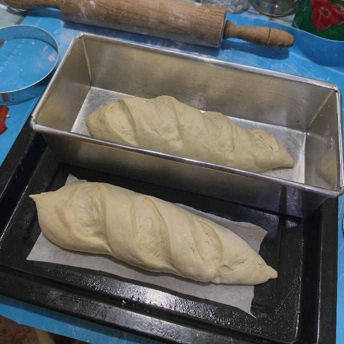two baguette dough, one inside a rectangular pan
