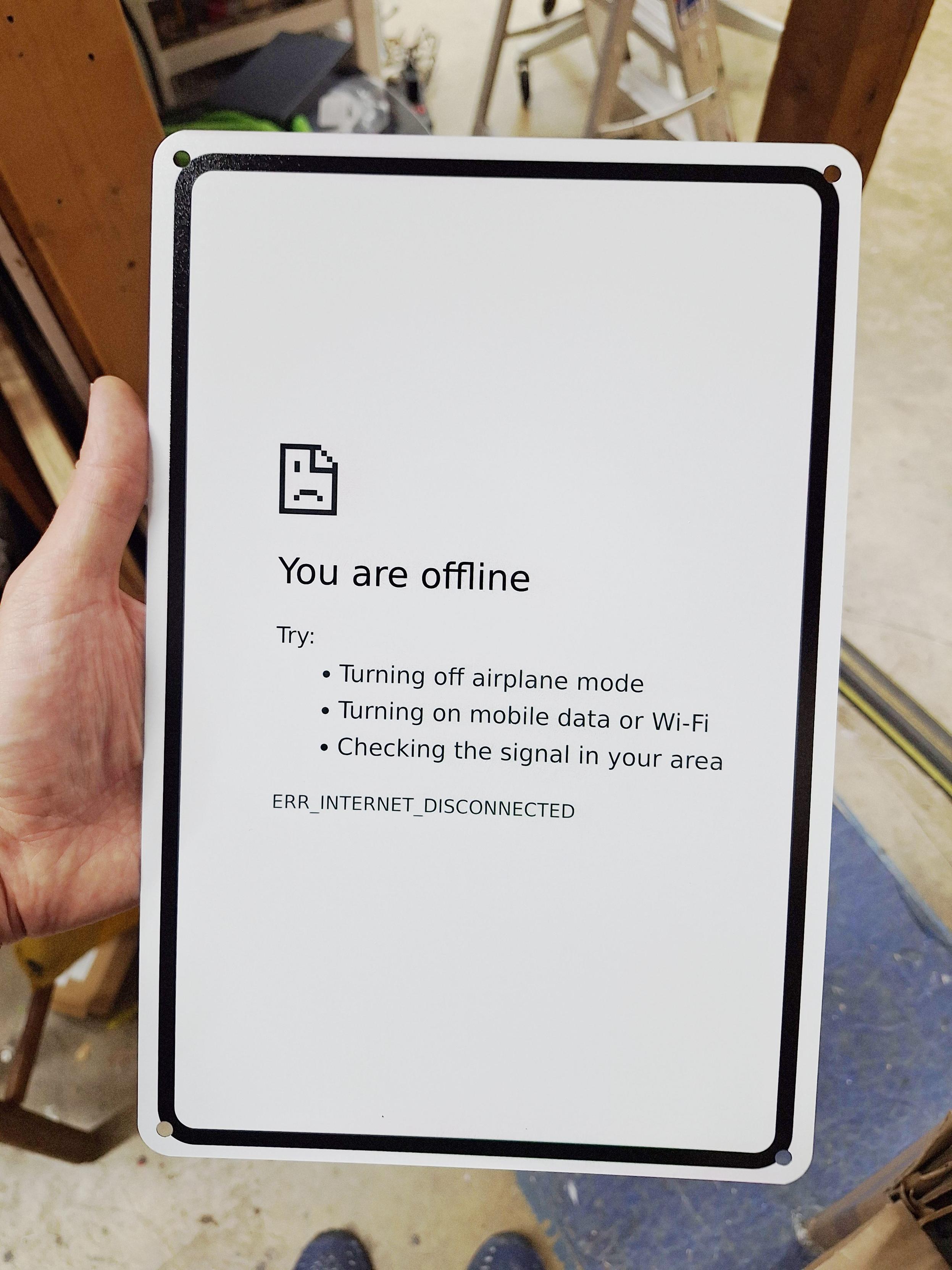 A sign like you might find on a pole out in the world, black on white text, except that it says, "You are offline. Try: Turning off airplane mode, Turning on mobile data or Wi-Fi, Checking the signal in your area. ERR_INTERNET_DISCONNECTED"