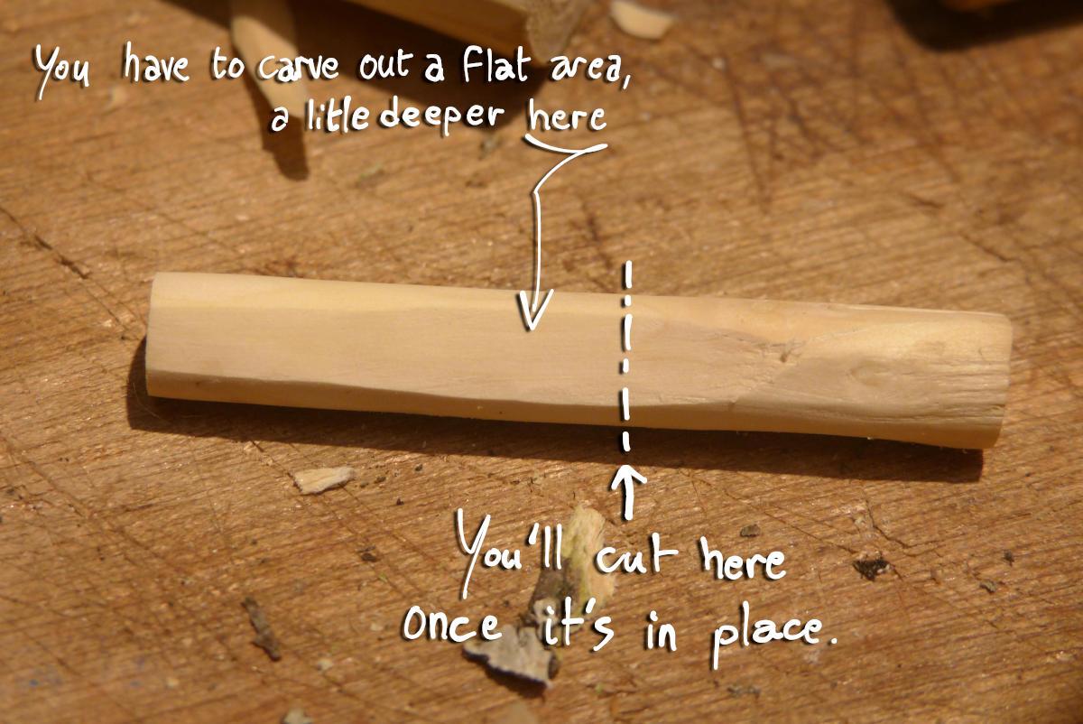 You have to carve out a flat area on the block, a little deeper on the side that will be on the tip of the whistle.