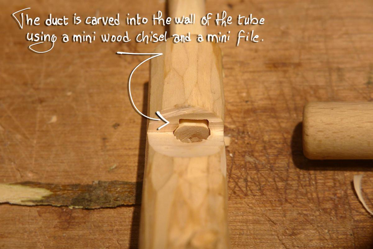 The air duct is carved into the wall of the tube using a mini wood chisel and  mini file.
