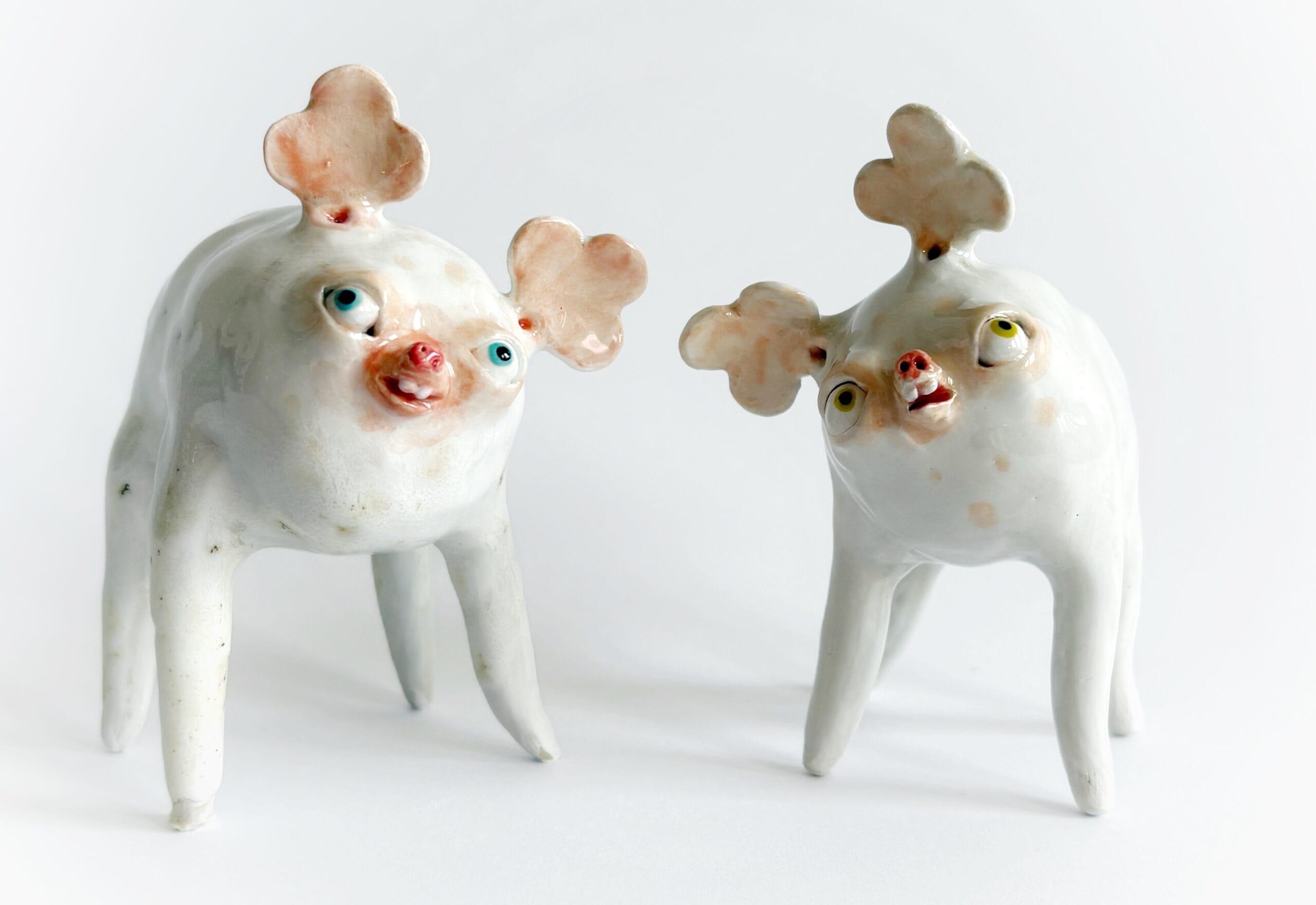 two cartoonish ceramic salt and pepper shakers in the form of quirky animals with clover-shaped ears