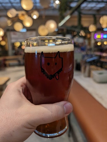 An amber beer with a picture of a cute wolf on the glass