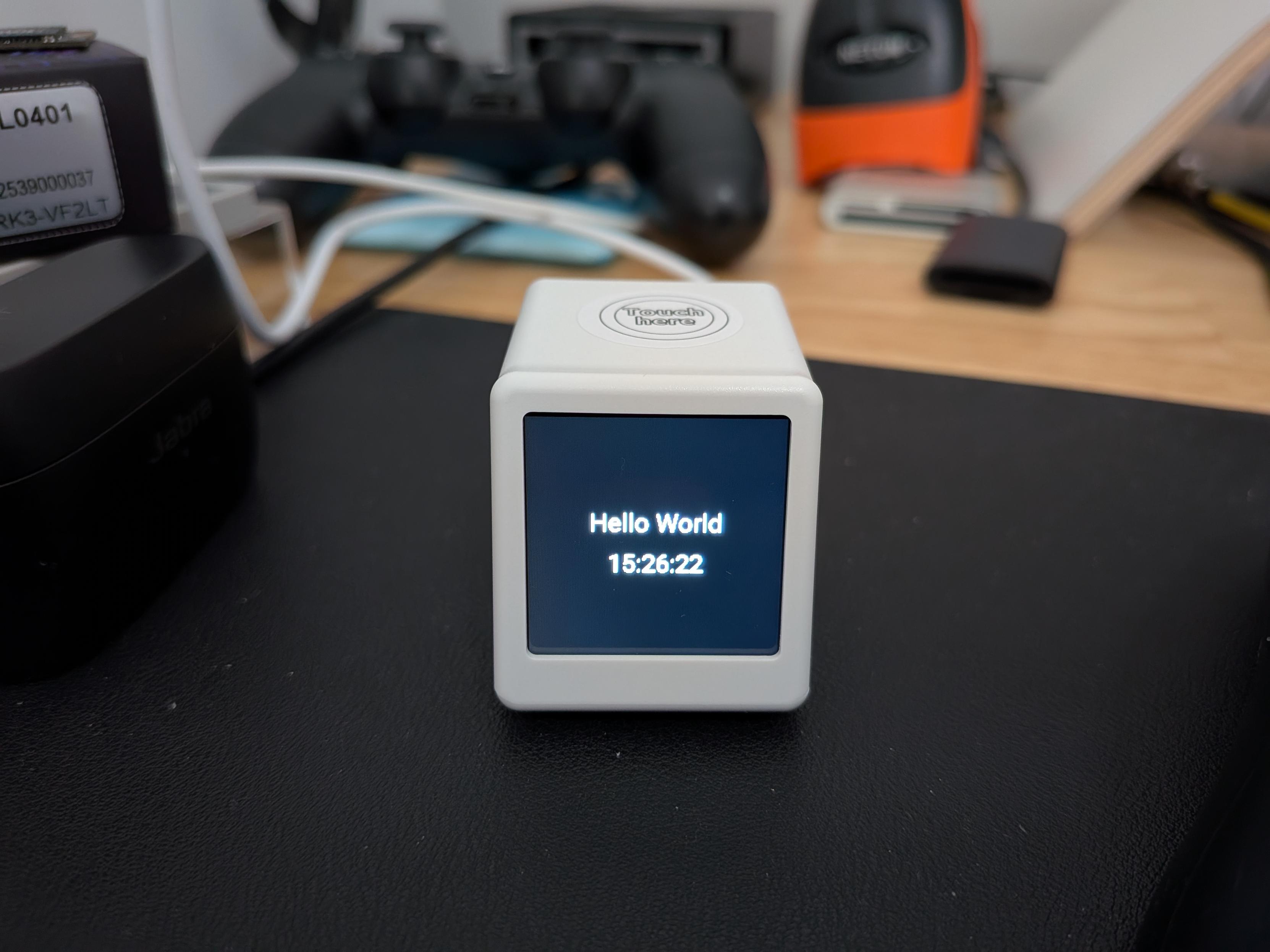 Small TV running custom esphome firmware. It's displaying the time and the text 'Hello World' on the display.