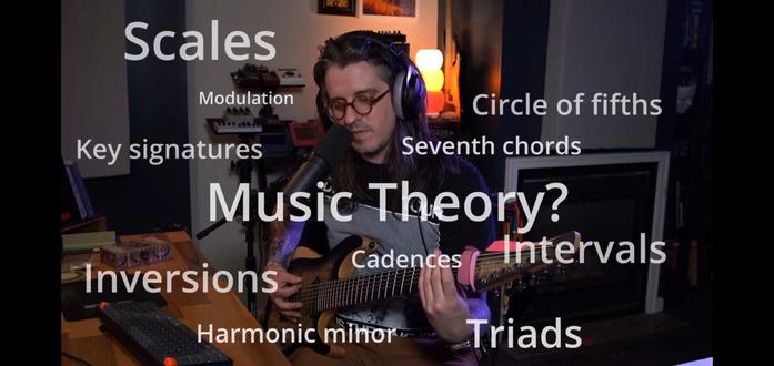 A screengrab of a YouTube video, a musician holds a guitar and ponders theory