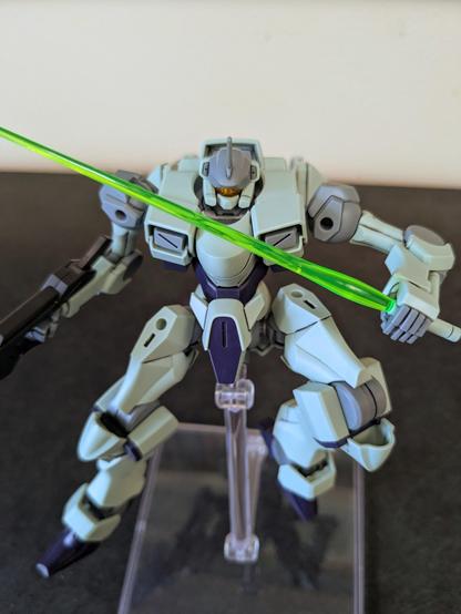 The HG Zowort on a stand in a defensive position, holding a beam saber across its body