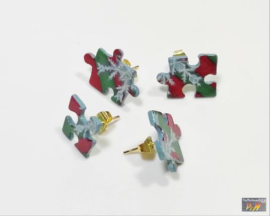 Four jigsaw piece earrings. laying apart.
