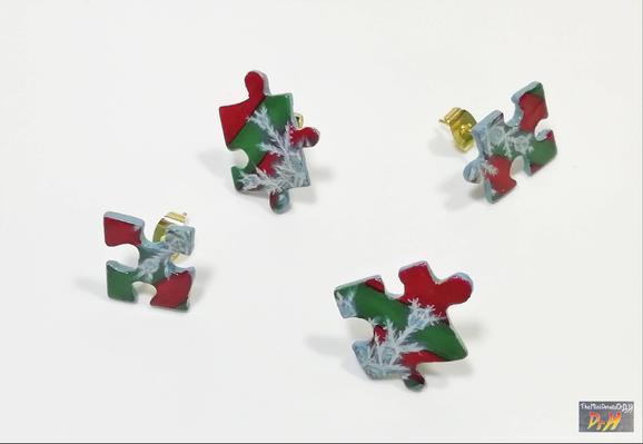 Four jigsaw piece earrings far apart.