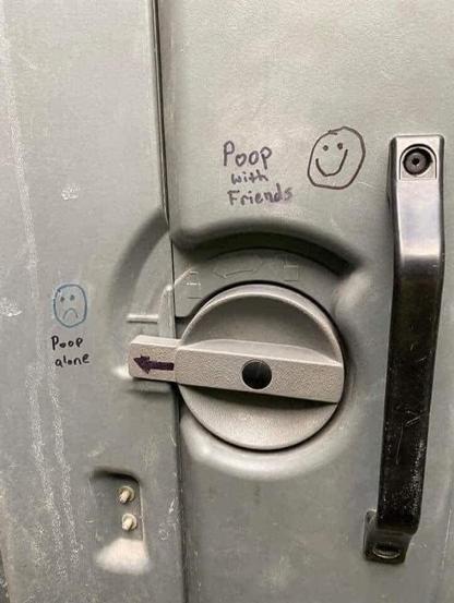 The lock for a Porta Potty is labeled Poop Alone and Poop With Friends.