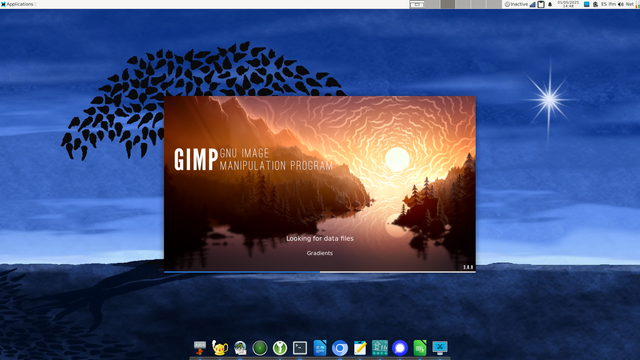 Screenshot of a XFCE desktop running Void linux and the startup splash window of the GIMP - GNU Image Manipulation Program - with a forest and a lake scene on a sunset