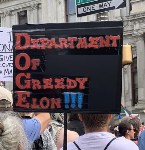 Philly May Day rally sign: Department of Greedy Elon (DOGE)