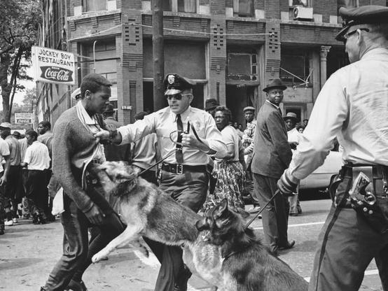 A 17-year-old, African-American Civil Rights demonstrator being attacked by a police dog in Birmingham, Ala., on May 3, 1963. This image led the front page of the next day's New York Times.