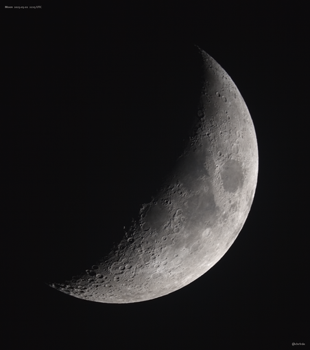 Thick "bowl-like" crescent phase. The bright, crisp and circular lunar edge is to the lower right. The dark terminator showing craters and shadows points to the upper left. The solid lit portion shows albedo feature like darker Mare.