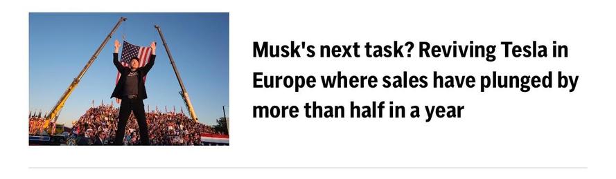 A nepo baby idiot man wearing a black suit is standing with his arms raised in celebration, holding an American flag. In the background, a crowd is gathered, and there are cranes with lights shining. The image is associated with an article discussing challenges faced by Tesla