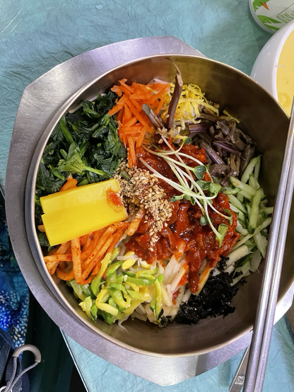 A bowl of bi bim bap with many colours