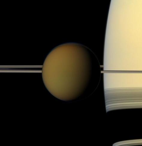 Titan passes in front of Saturn in this image from NASA's Cassini spacecraft.

The colorful globe of Saturn's largest moon, Titan, passes in front of the planet and its rings in this true color snapshot from NASA's Cassini spacecraft.

NASA/JPL-Caltech/Space Science Institute


Titan Facts

Titan is Saturn's largest moon, and the only moon in our solar system known to have a substantial atmosphere. Titan is the only place besides Earth known to have liquids on its surface. It has clouds, rain, rivers, lakes and seas of liquid hydrocarbons like methane and ethane.