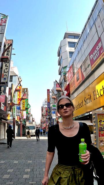 Katheirne is photographed by Duane in the Ueno neighborhood of Tokyo. She wears a chunky solid silver necklace and earrings by Xover0.