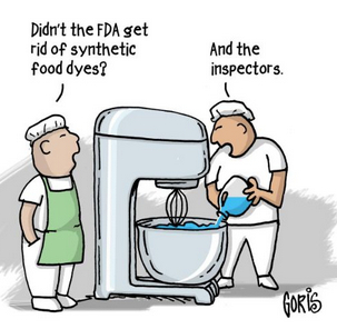 The cartoon shows two men in food production. One says: "Didn't the FDA get rid of synthetic food dyes?" The other pours synthetic food dyes into a large blender and says: "And the inspectors."
