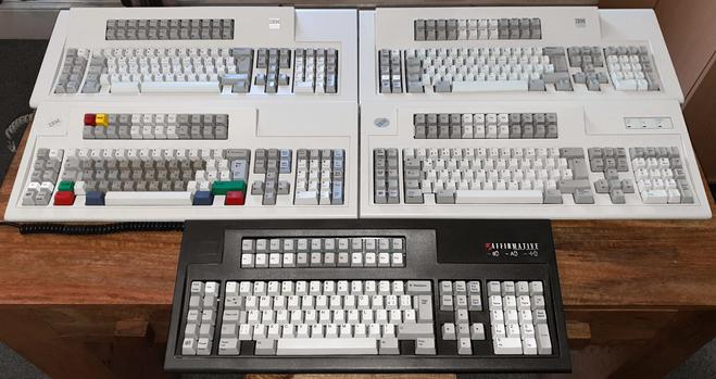 A photo of various 122-key Model M Converged Keyboards from IBM and Unicomp