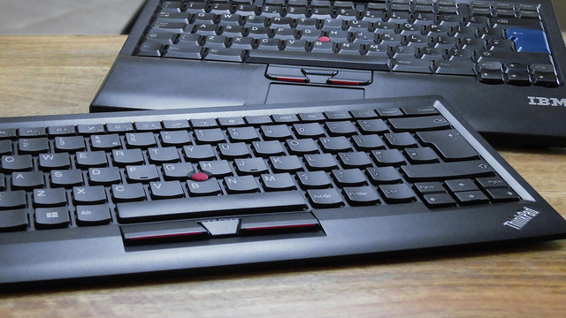 A photo of an IBM PS/2 Travel Keyboard with UltraNav (SK-8840, top) and a Lenovo ThinkPad Compact USB Keyboard with TrackPoint (KU-1255, bottom)