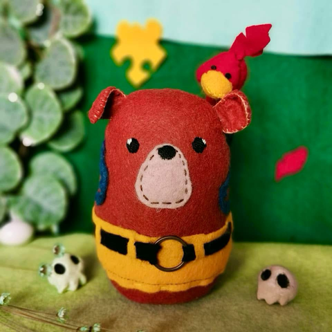 Another picture of the plushie, this time, the bird is inside the working backpack, peaking out from behind the bear’s head.
