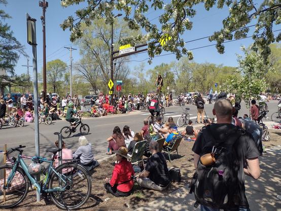 A group of bicyclists riding unusual bicycles in a street parade.