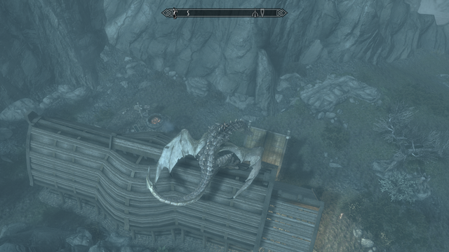Modded Skyrim screenshot: The player, a large dragon, perches on his house, Hendraheim. To the bottom right of the screenshot, a tiny human figure stands staring into the distance.  This is the Courier, Skyrim's notorious postal worker.  Since the dragon is perched on the roof, he is unable to reach them to deliver a letter from the Empire and has either given up completely or is waiting for them to come down.

This was made with Play-As-A-Dragon SE