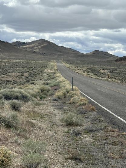 Mountains, sky, thicker clouds, sagebrushes.