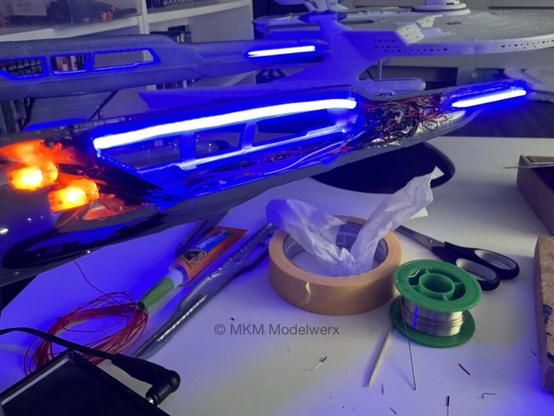 Closeup of the port nacelle with the orange and blue lights lit.