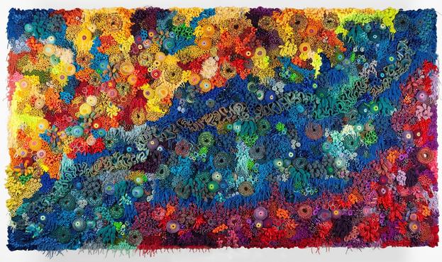 a vibrant fiber work evoking corals, molds, and other organic forms