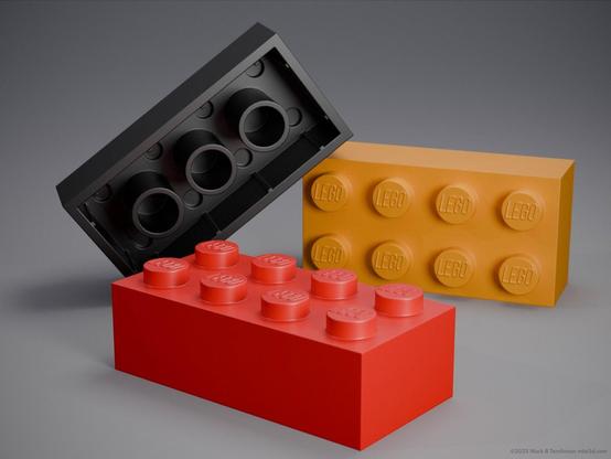 three 8 stud LEGO bricks in red black and gold